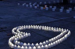 Two rows of candles formed into the shape of a heart.