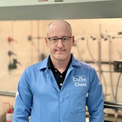 Person wearing a lab coat.