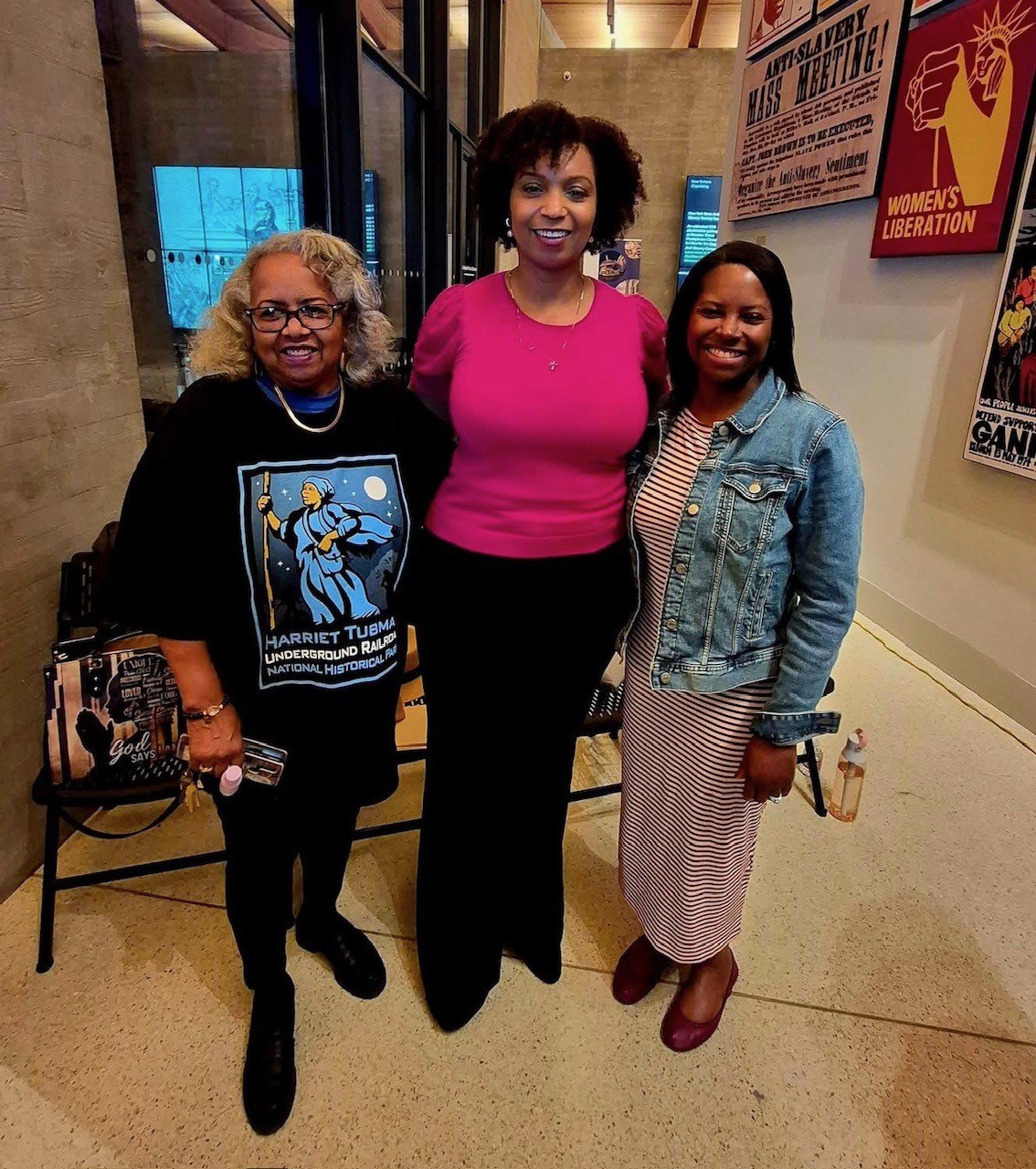 Three women stand side by side