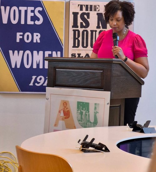 Tanisha Jackson speaks behind a podium