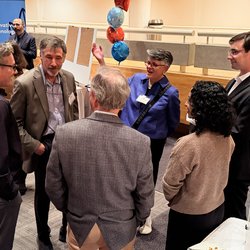 Group of people in a circle talking.