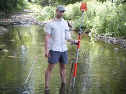 Ryan Gordon samples water in a stream