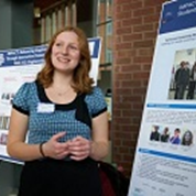 Woman giving a poster presentation.
