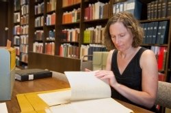 Carol Faulkner, chair of the Department of History, examines historic documents in Bird Library Archives