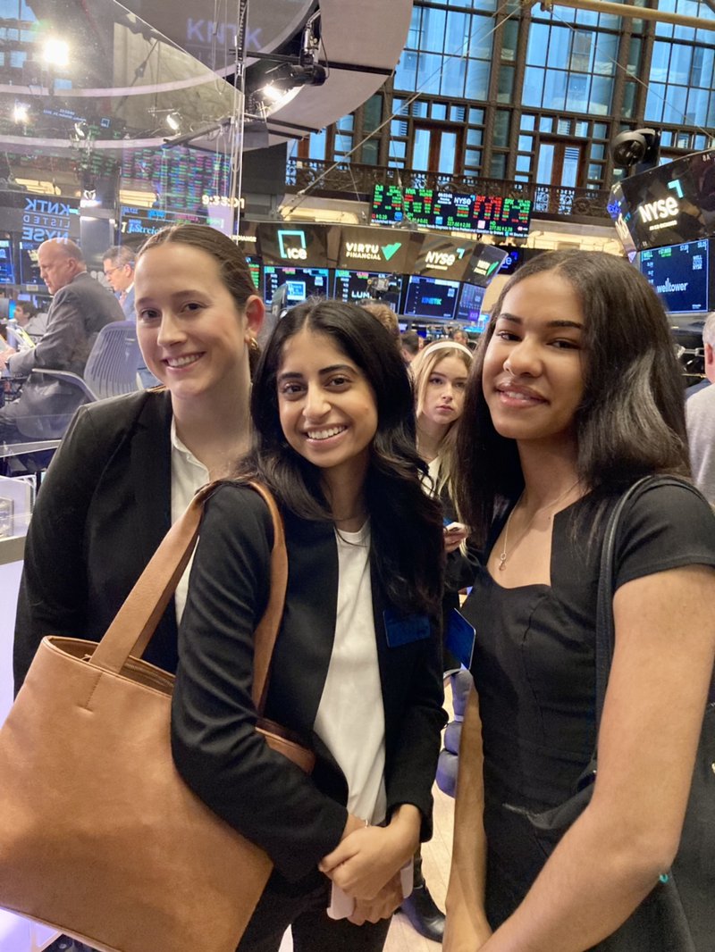Female students on stock exchange floor.