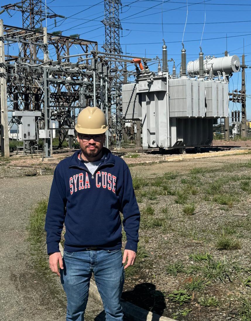 Person standing in front of a power transformer.