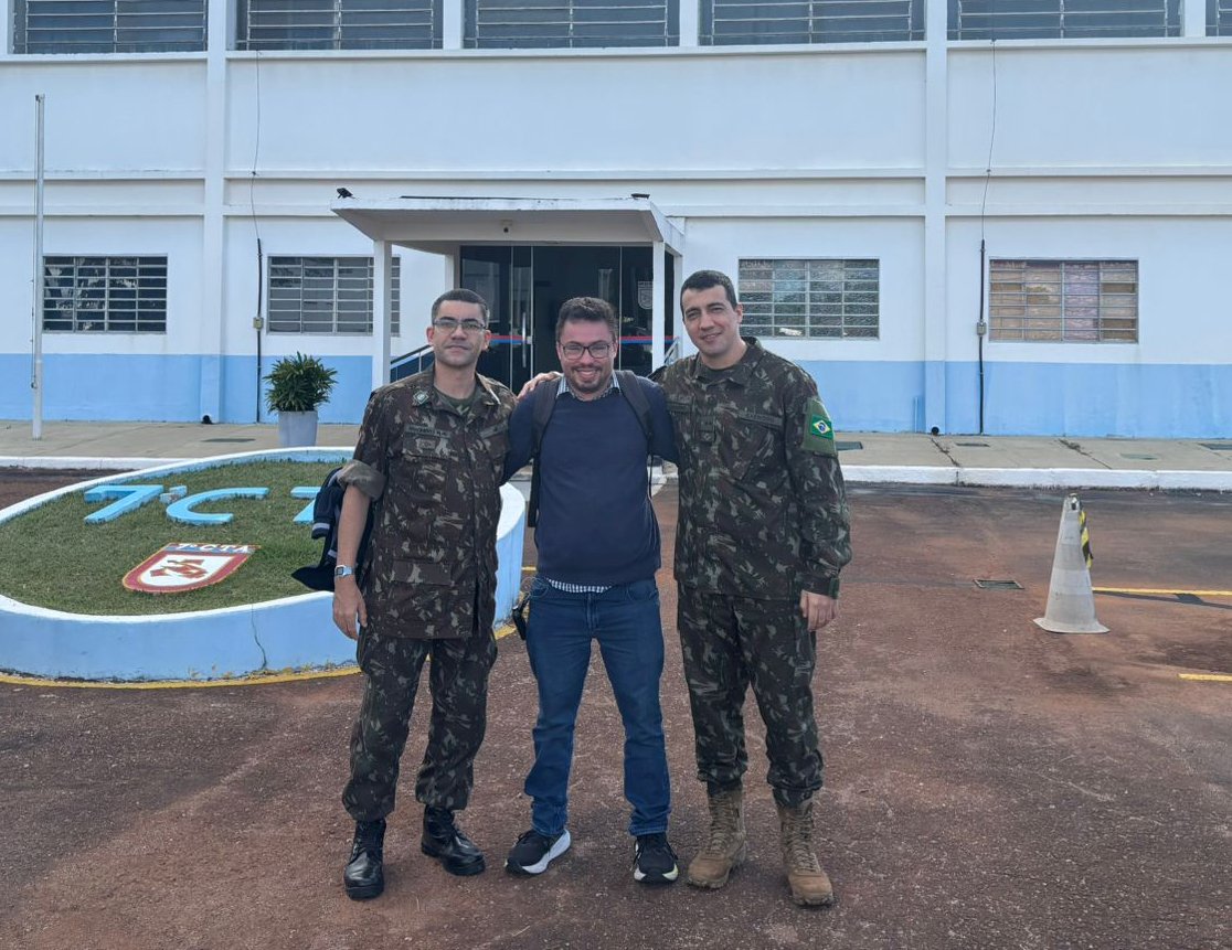 Three people standing in front of a building.