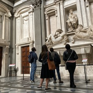 Students examining a sculpture