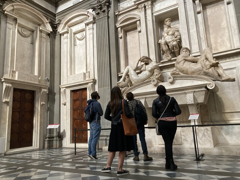 Students studying a sculpture