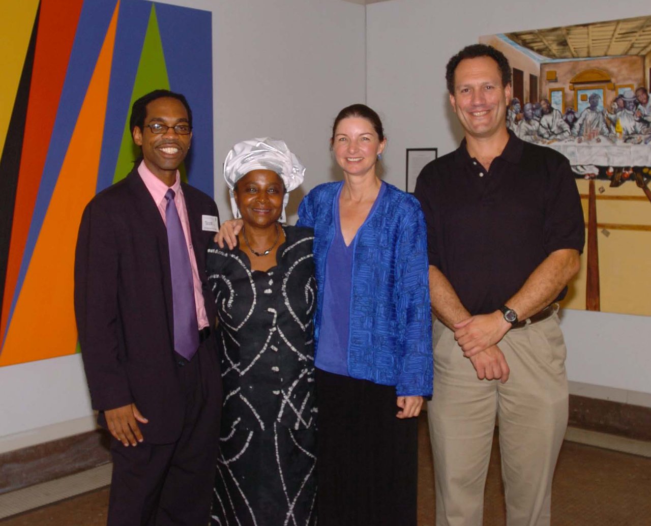 Four people standing in an art gallery.