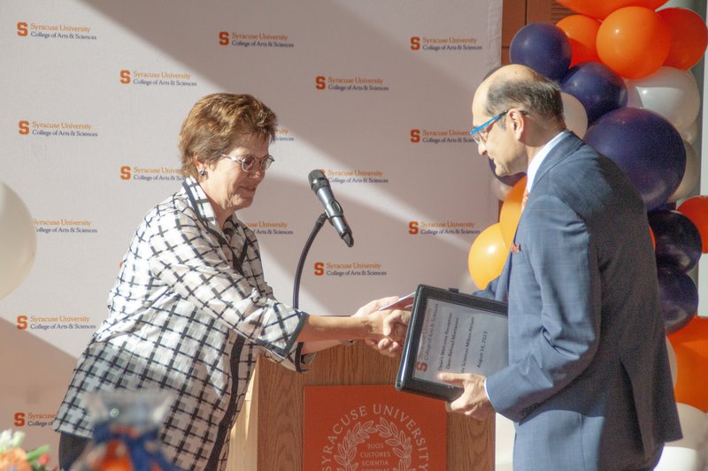 Gretchen Ritter Shaking Hands with Behzad Mortazavi.