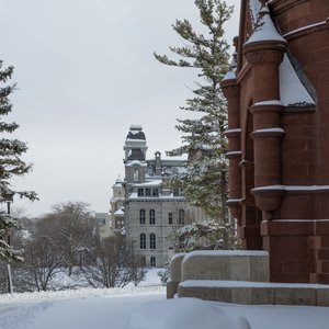 Snowy photo of Hall of Languages with Crouse in the foreground.