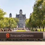 Syracuse University sign with Hall of Languages in the background.