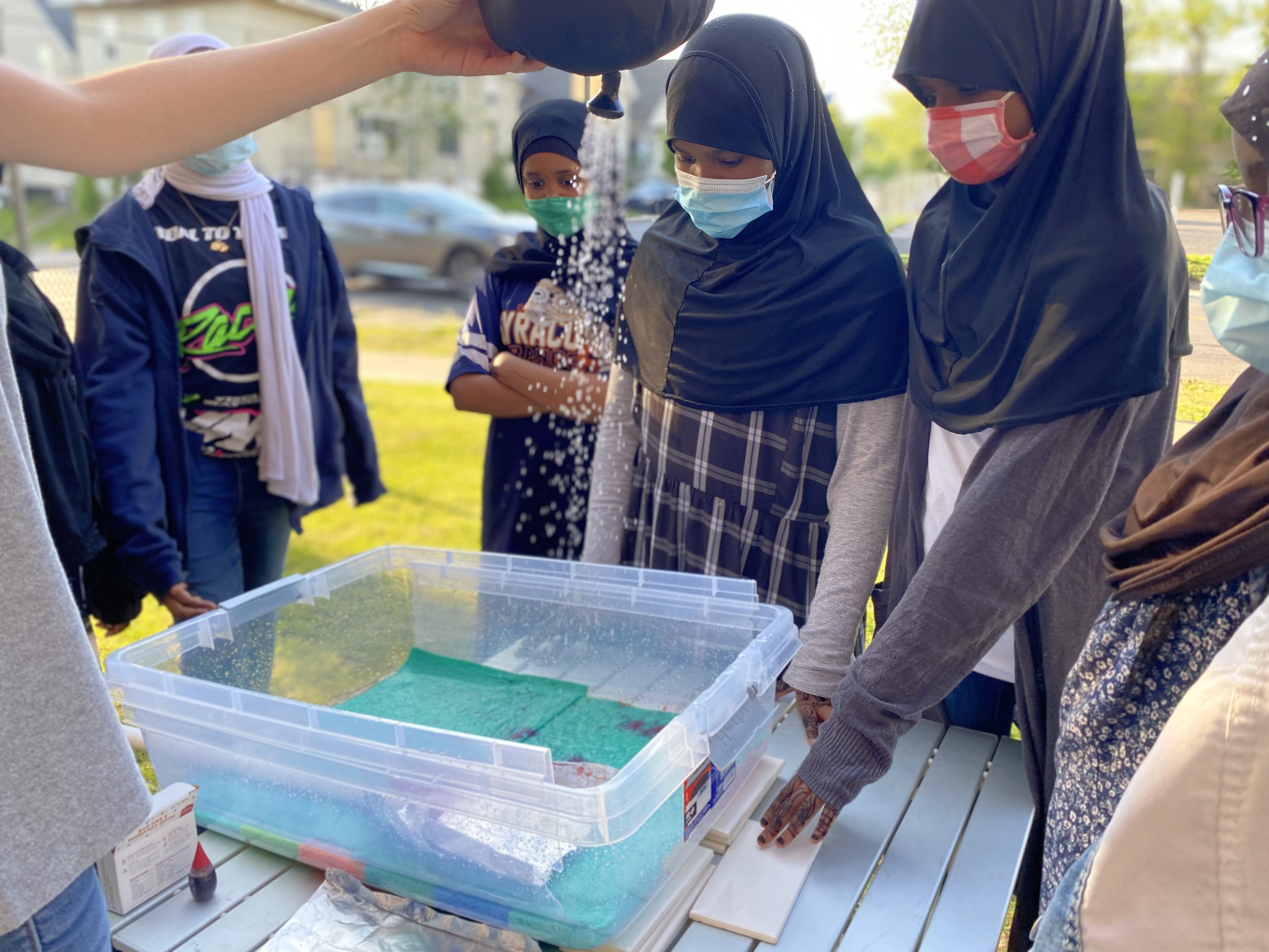 North Side Learning Center students watching a hydrology demonstration.