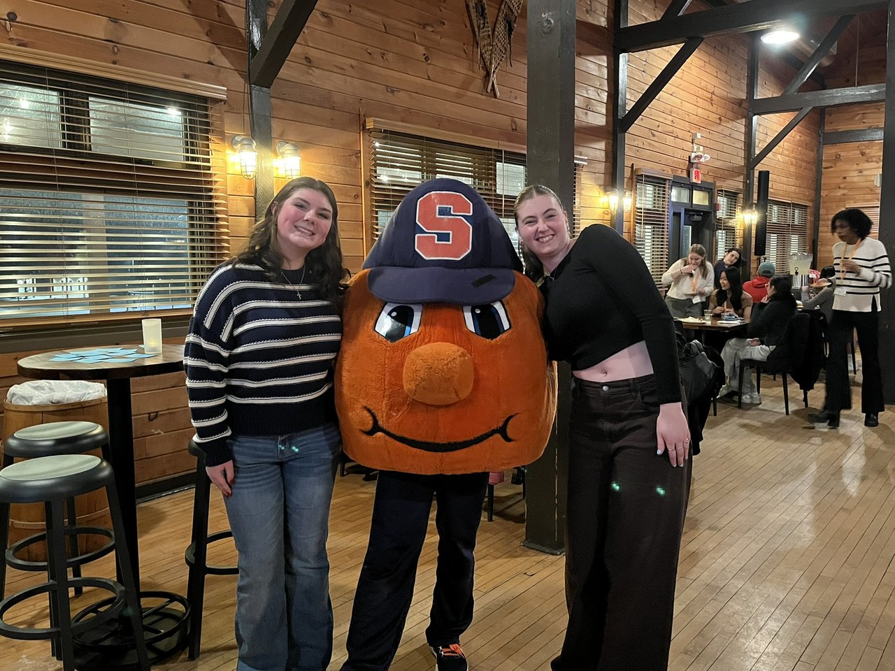 Students with Otto the Orange at an event at the Inn Complete
