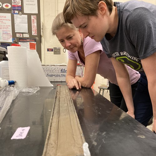 Staff technician Jacqueline Corbett and graduate student Laura Streib examine a sediment core from Oneida Lake.