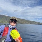 Julia Zeh holding a suction cup tag aboard a boat on the ocean.