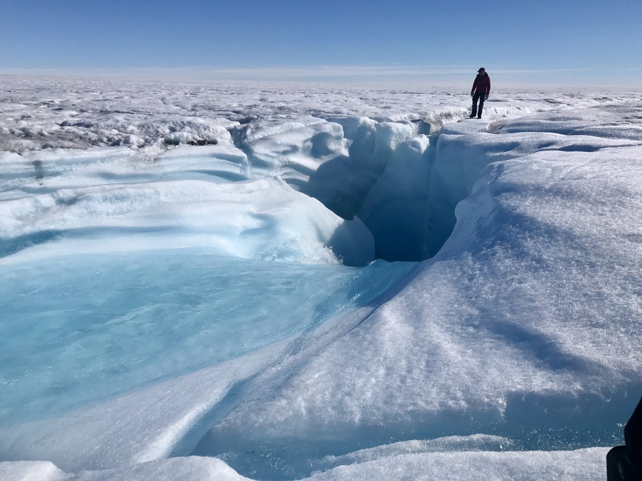 Person standing on an ice sheet.