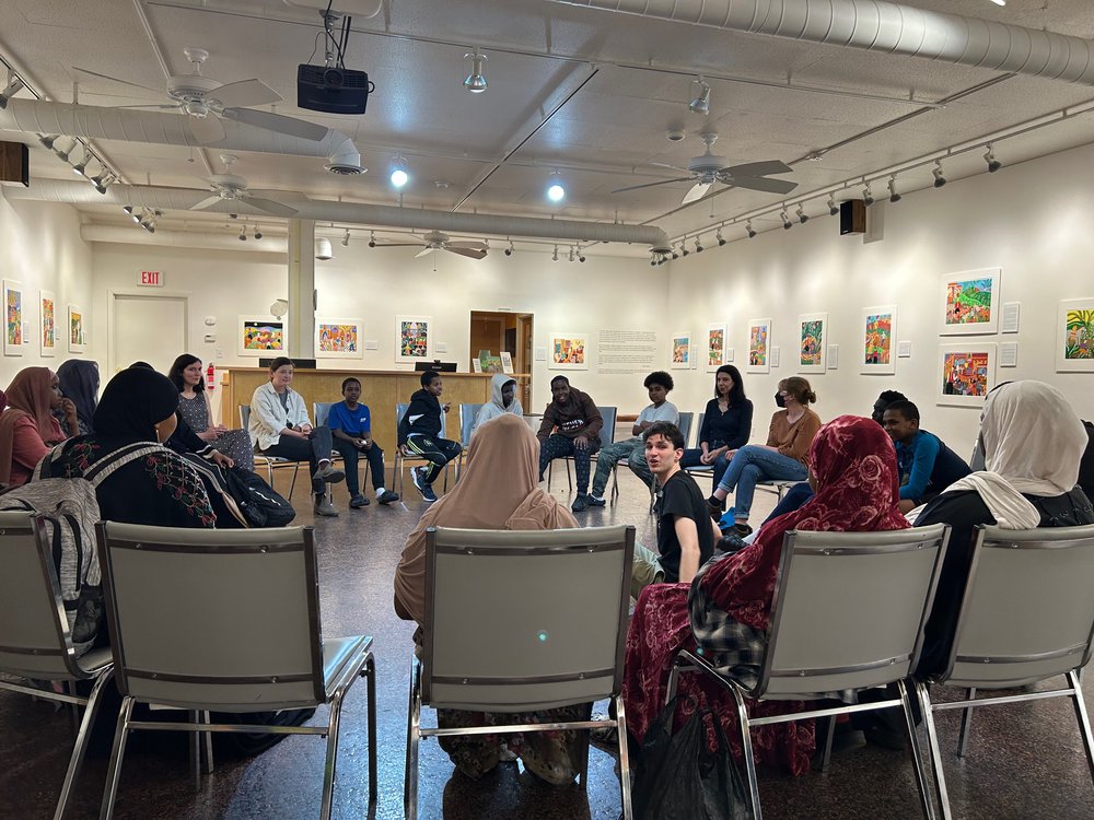 Local students sit in circle for storytelling workshop with artist Helen Zuhaib at local art gallery