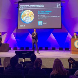 Person addressing a large crowd of people.