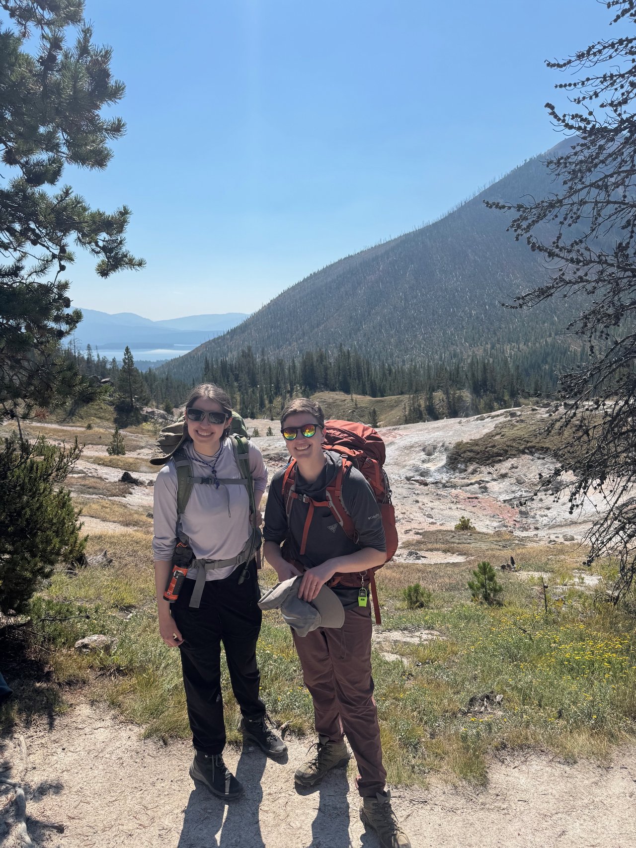 Two people standing in Yellowstone National Park.
