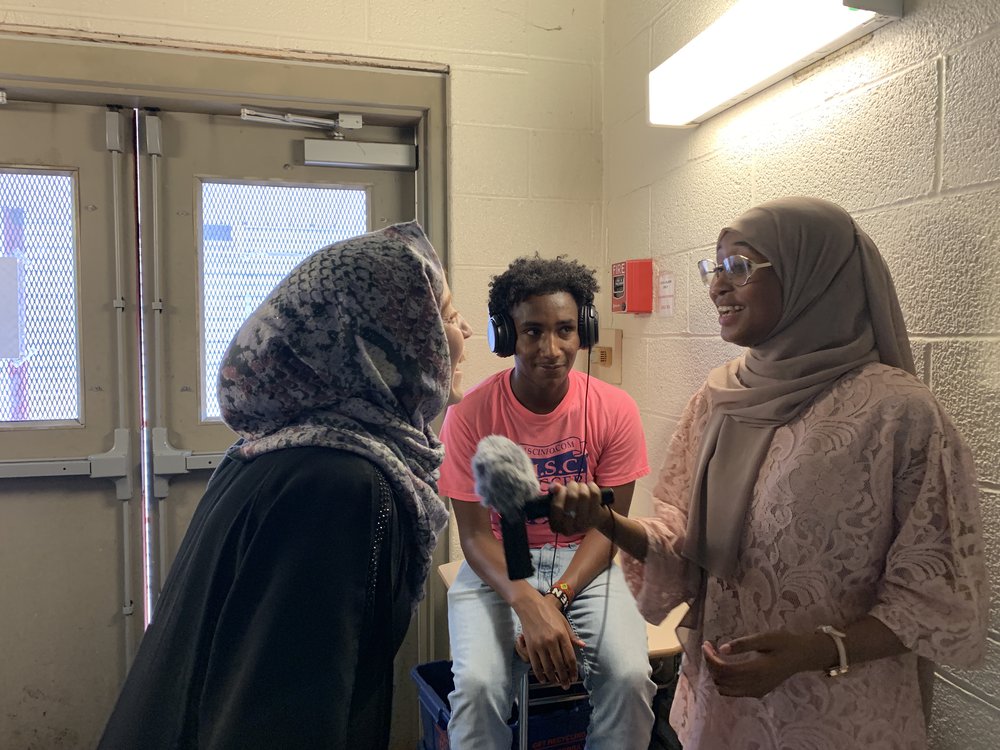 Engaged humanities undergraduate research assistants interviewing students at the North Side Learning Center