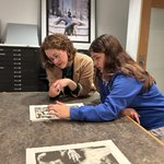 Two people viewing an art work.