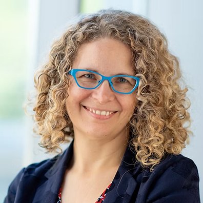 Woman with blonde curly hair and glasses