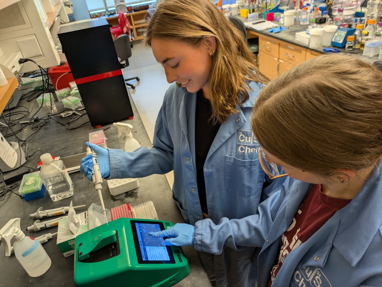 Two people working in a lab.