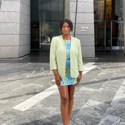 Linda Baguma standing in front of 10 Hudson Yards building.