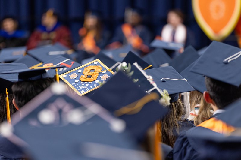 graduation cap with the Syracuse S logo on it