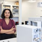 Woman standing in a lab.