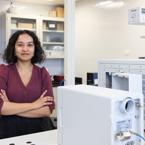 Woman standing in a lab.