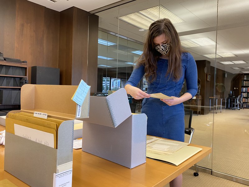 student examining archival material