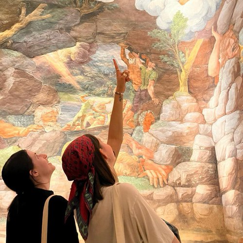 Two people looking up at a masterpiece.