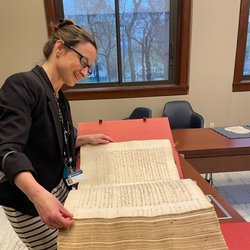 Lia Markey looking at a book.