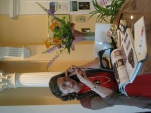 Mary Gilbert Palmer '65 (B.S. political science) examines antique jewerly in her home. 