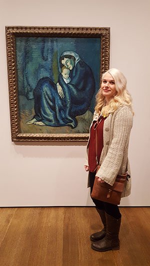 McGrath standing near a Picasso painting.