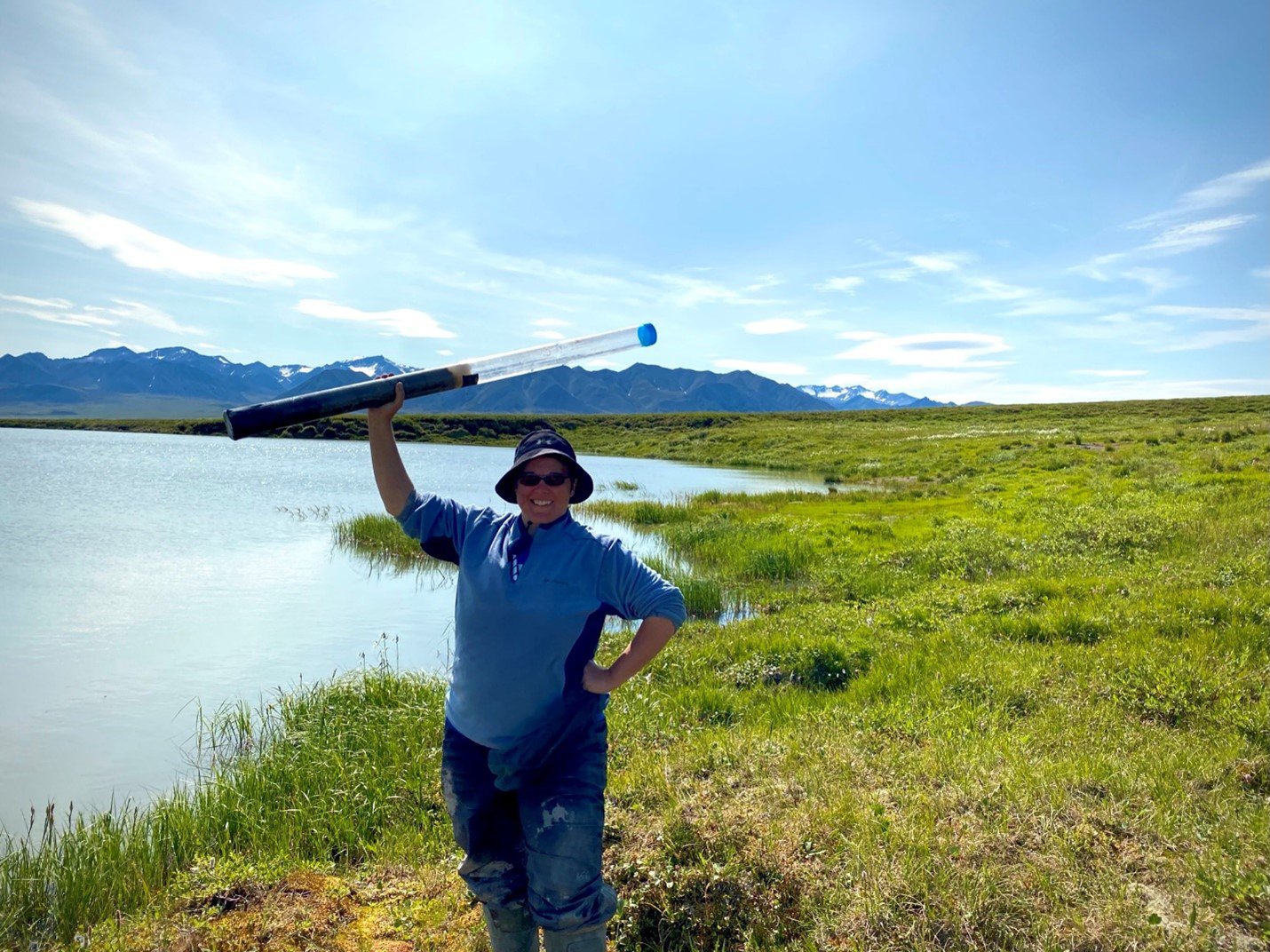 Melissa holding a lake core over her head