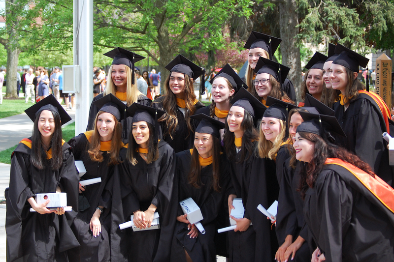 grad students pose for a graduation picture