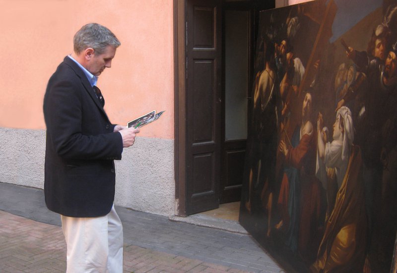 Wayne Franits examining a large painting