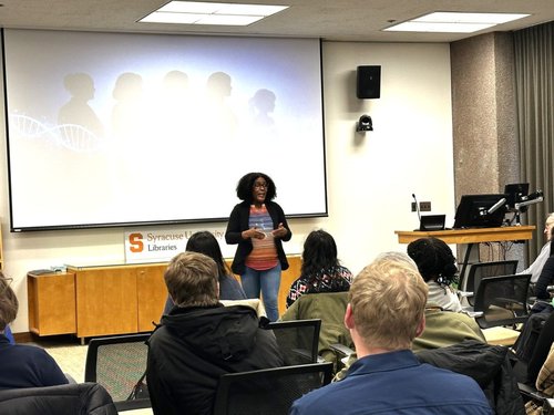 Person presenting research to a room.