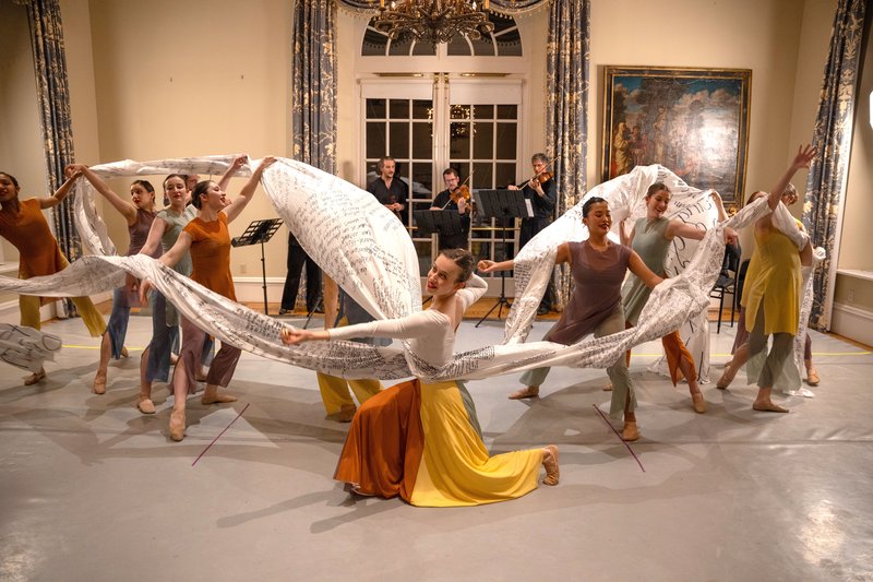 Dancers and musicians performing in a room.