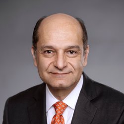 Behzad Mortazavi in a black suit with a red tie