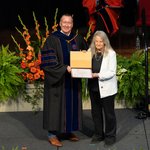 Person accepting an award from another person.