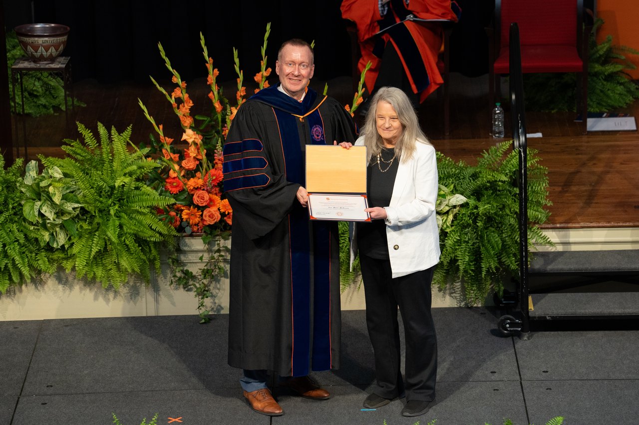 Person accepting an award from another person.