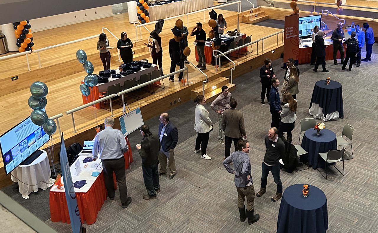 Room full of people mingling.