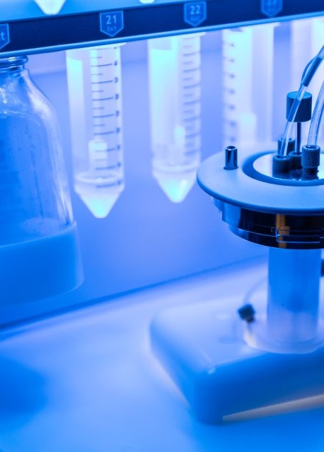 Blue background with peptide synthesizer in the foreground