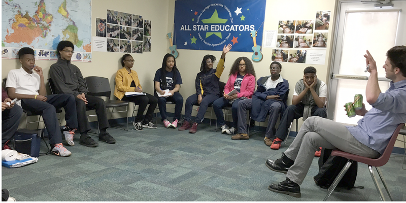 Group of students seated in a half circle.