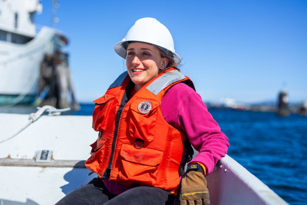 Woman in a hardhat on a boat.